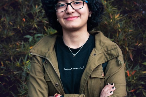man in brown leather jacket smiling